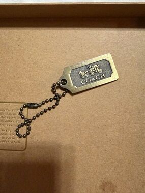 Coach Brass Tag Keychain in Antique Gold and Dark Metal